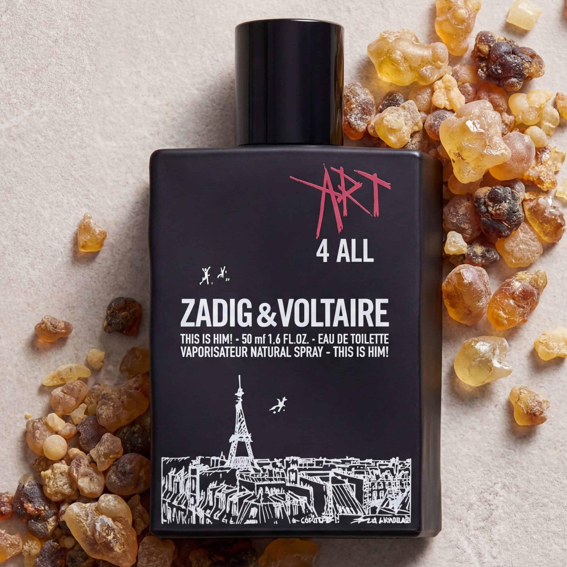 Vaporizer perfume bottle with Zadig & Voltaire "Art 4 All" fragrance surrounded by amber resin stones.